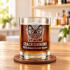 Personalized whiskey glass with a ram mascot and “Coach Simmons, 2022 Championship Season” engraving on a leather coaster in a bright home bar.