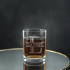 Elegant custom-engraved whiskey glass in bold, monogrammed initials, presented on a reflective surface with a sophisticated dark background, perfect for personalized gifts and special occasions.