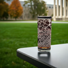 Custom engraved highball glass with State College map, elegantly displayed on an outdoor table with the Penn State University campus grounds in soft focus in the background, ideal gift for Penn State students, alumni and fans.