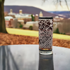Laser etched highball glass featuring a detailed map of State College, PA, set against a soft-focused background of the Penn State University campus, ideal for alumni and fans seeking unique Penn State-themed glassware.