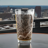 Laser etched 16oz pint glass featuring a detailed map of Philadelphia, PA, highlighting University City and Center City. A unique, Philly barware gift, perfect for locals, alumni, and city lovers. Optional personalized engraving available.