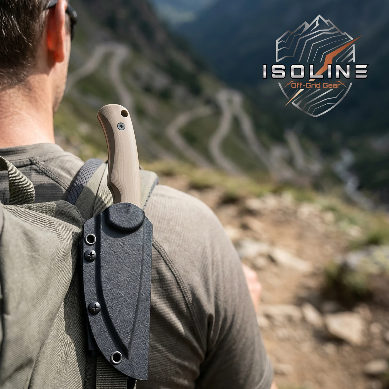 Isoline Desert Gray in Kydex sheath clipped to a backpack, hiker looking out over the terrain