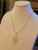 Elegant outline filigree petal necklace in gold alloy