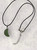 Green aventurine semiprecious Crescent Moon pendant on black cord necklace