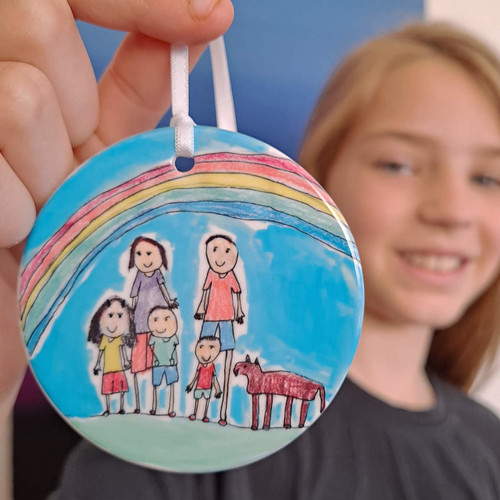 Child holding artwork ornament