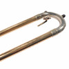 Close-up of the curved end of the Bach Soloist trombone handslide with visible scratches and finish wear. card