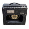 Rear view of Supro Amulet combo amplifier showing open-back cabinet, rear connections, identification plate, and Celestion G10 speaker. card