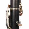 Close-up of the lower joint showing the serial number area, thumb rest, and natural wood grain on the Buffet Crampon professional B♭ clarinet. card