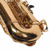 Close-up of saxophone bow and lower body showing numerous scratches and scuffs in the gold finish. card