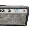 Front-right detail showing the Bassman 100 logo, Master Volume control, power indicator, silverface panel, grille cloth, and worn cabinet corner. card