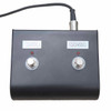 Close-up of the black two-button footswitch labeled “DUCK” and “COVER,” with indicator lights, attached cable, and light surface scratches. card