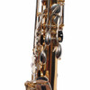 Close-up of rear saxophone keywork with silver-colored levers and black key touch. card
