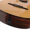 Close-up of the Taylor 212ce-N bridge showing the ebony bridge, compensated saddle, and nylon string tie block. card
