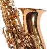 Close-up of the engraved Evette by Buffet Crampon bell and lower keywork showing scratches, pitting, and lacquer loss around the bell rim. card