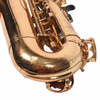Close-up of the lower bow and bell key guard showing dense scratches, finish wear, and lacquer loss across the brass surface. card