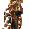 Close-up of the lower keywork showing scratched and worn lacquer on the keys, rods, and body tube, with a black thumb rest. card