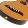 Close-up of the Washburn Rover RO10 bridge, bridge pins, strings, and lower bout with natural finish.