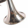 Close-up of the silver-plated trumpet bell showing light surface scratches and cosmetic wear. card