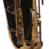 Close-up of the lower body showing the serial number and finish wear on the used 1939 King Zephyr tenor saxophone.