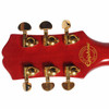 Rear view of the Epiphone Sheraton headstock showing gold tuning machines and the 150th Anniversary emblem. card