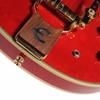 Close-up of the Bigsby vibrato tailpiece with wooden accent, output jack, and Cherry finish on the Epiphone Sheraton. card