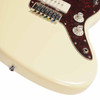 Close-up of the lower body showing the adjustable bridge, bridge pickup, control knobs, and Olympic White finish on a Squier Jazzmaster XII. card