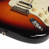 Close-up of the tremolo bridge and output jack on a Fender American Professional Stratocaster HSS in 3-Color Sunburst. card