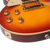 Close-up of figured maple top showing four amber control knobs, bridge, tailpiece and output jack. card