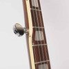 Close-up of Lyle banjo fretboard showing fifth-string tuning peg, rectangular inlays, frets, and binding. card