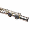 Close-up of the flute footjoint showing the silver-plated keys and closed-hole key cups. card