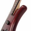 Close-up side view of the upper body horn and neck joint showing the rounded contours and burgundy red satin finish. card