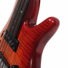 Close-up of the upper body and cutaway showing the figured red-brown finish and light surface marks near the neck joint. card