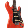 Angled front view of Coyle Beatles Collection electric guitar showing the orange body, black Beatles pickguard, cream pickups, chrome bridge, and decorative graphics. card