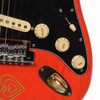 Close-up of the guitar controls and hardware showing cream volume and tone knobs, pickup selector, chrome bridge, and output jack. card