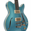Angled front view showing the Celestine Blue finish, cream binding, dual pickups, f-holes, controls, and tremolo. card