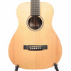 Close-up front view of Martin LX1 Little Martin acoustic guitar showing natural top, soundhole, bridge, and fretboard. card