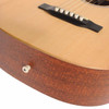 Close-up of Martin LX1 bridge and lower body showing natural top, white bridge pins, and side-mounted strap button. card