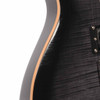 Close-up of the guitar's upper body edge showing light scratches in the black finish near the natural-colored binding. card