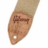 Close-up of cork guitar strap end with Gibson logo, stitching and strap button hole. card