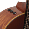 Close-up of three black onboard electronics control knobs on the upper side of the guitar. card