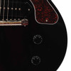 Close-up of bridge, P-90 pickup, tortoiseshell pickguard, and volume and tone controls. card