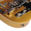 Close-up of lower gold body showing Bigsby vibrato, chrome controls, cream binding, and output jack. card