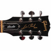 Close-up of the black Gibson Les Paul Studio headstock with chrome tuning machines and gold Gibson and Les Paul Model logos. card