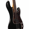 Angled front view highlighting the glossy black body, tortoiseshell pickguard, pickup, and control knobs. card