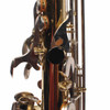 Close-up of rear keywork and black thumb rest with visible finish wear and small marks. card
