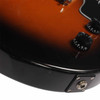 Close-up of lower body edge showing finish scratches and scuffs near the output jack. card
