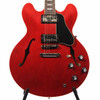 Front body close-up of Sixties Cherry Gibson ES-335 with dual humbuckers, F-holes, and nickel hardware. card