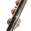 Close-up of flute body with engraved serial number and surface scratches. card