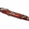 Close-up of bassoon keywork and tone holes mounted on the reddish-brown maple body. card