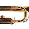 Close-up of worn lacquer and discoloration on trumpet slide tubing near curved bend. card